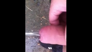 chav pissing and wanking in a field