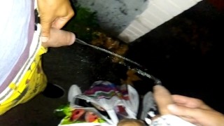 Boys pissing together near the bar