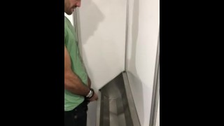 Buff Uncut Hottie Smiles as He Pees into the Urinal Trough.