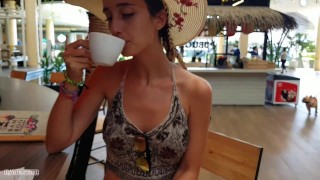 Lady in a hat without panties under a skirt in a shopping center