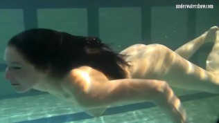 Dressed up teen Irina Barna swims sexy in the pool