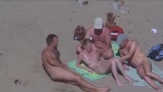 Strangers come to cuckold couple on nude beach, wife jerks them off