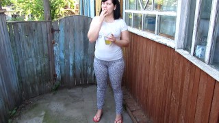 brunette girl smokes and pisses in a glass