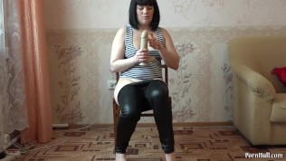 A young brunette with small tits fucks with a big dildo and sucks it