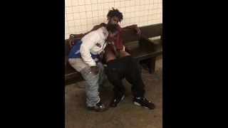 Two homeless black men having oral fun at a subway station